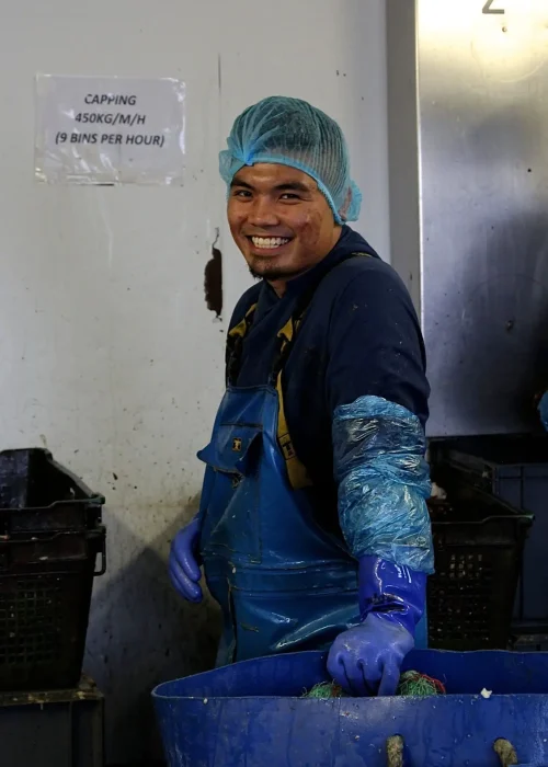 A smiling Central Sea Crab factory worker
