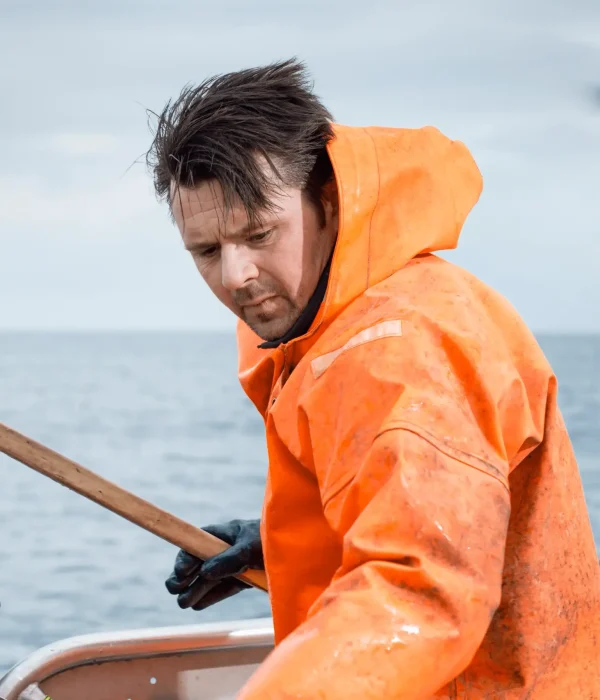 Fisherman in an orange raincoat
